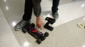 Showing students how to turn the cars on with the controller